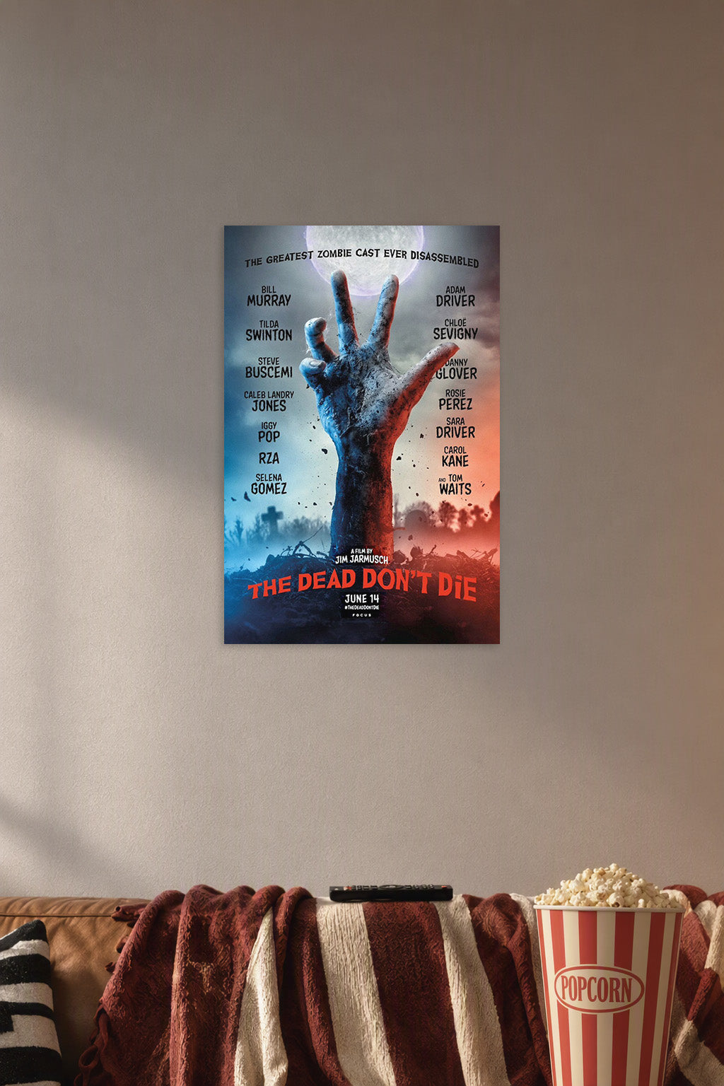 The Dead Don't Die Movie Poster in a cozy movie room above a brown sofa with popcorn.