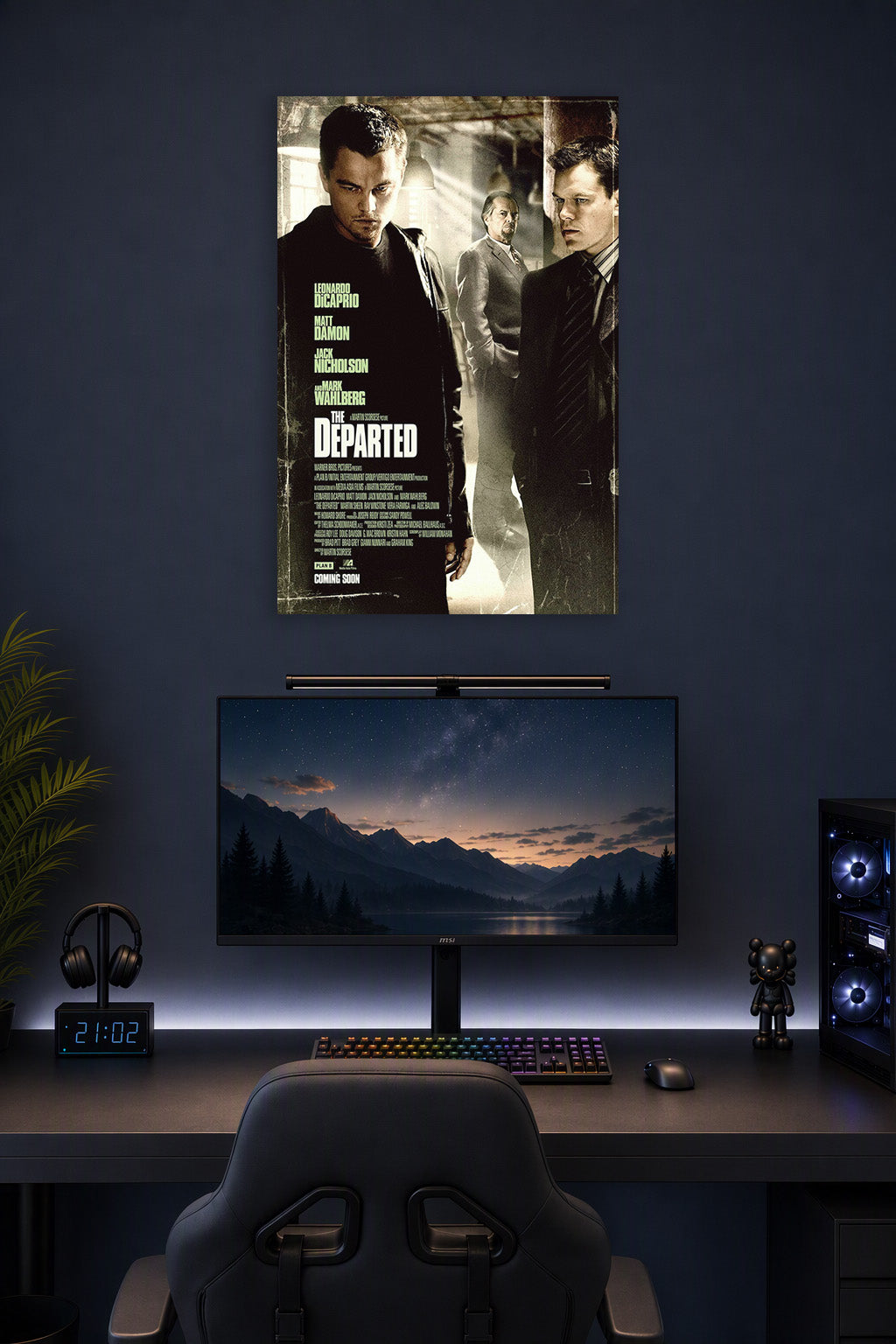The Departed Movie Poster in a gaming desk setup above a monitor.