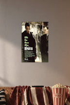 The Departed Movie Poster in a cozy movie room above a brown sofa with popcorn.