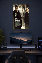 The Departed Movie Poster in a gaming desk setup above a monitor.