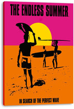 The Endless Summer canvas wall art print displays surfers with longboards on an orange beach against a pink sky and yellow sun.