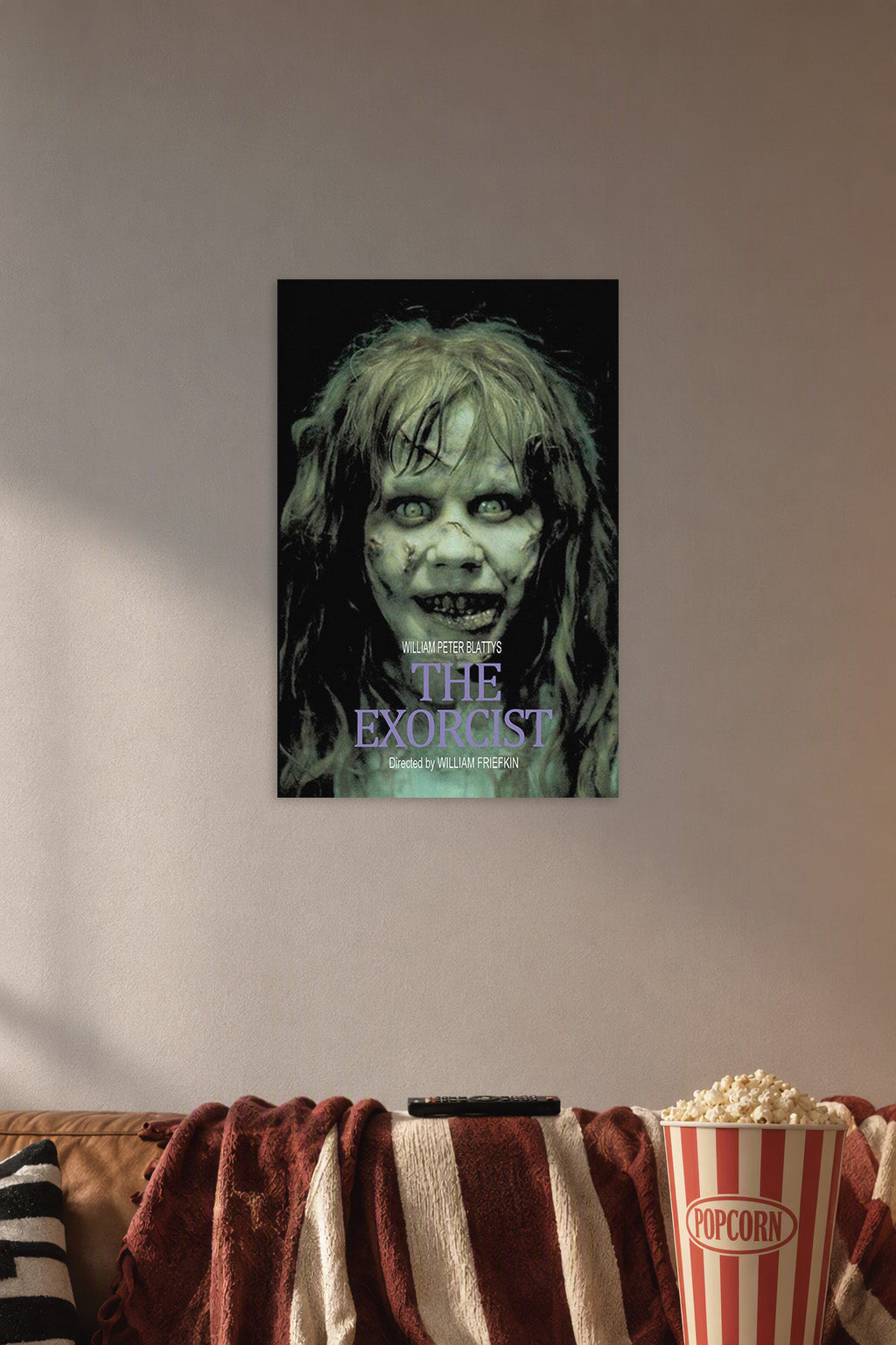 The Exorcist Movie Poster - Regan MacNeil in a cozy movie room above a brown sofa with popcorn.