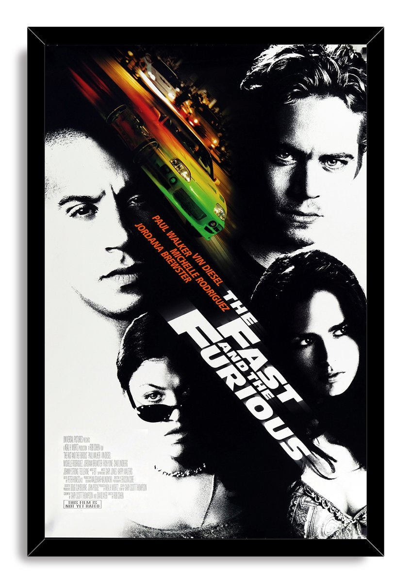 The Fast and the Furious framed wall art print features four stark cast portraits and a green sports car amid orange motion trails.