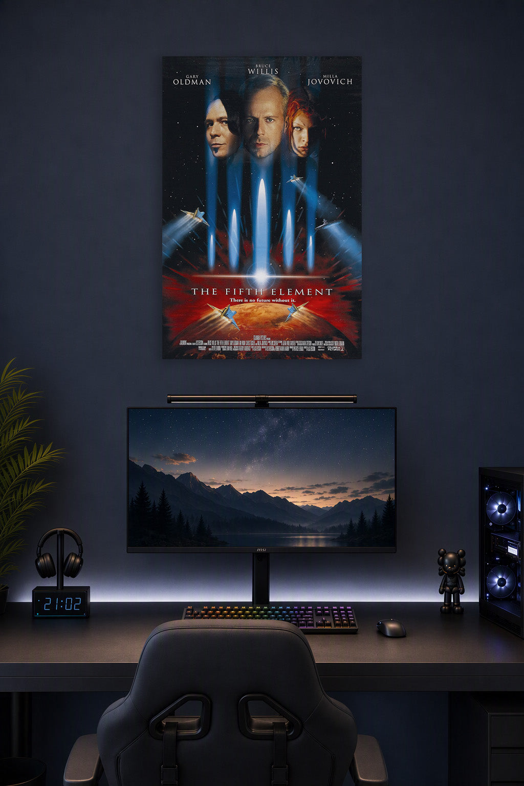 The Fifth Element Movie Poster in a gaming desk setup above a monitor.