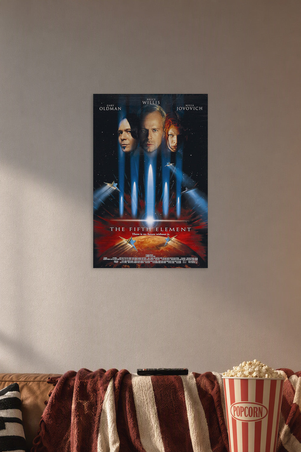The Fifth Element Movie Poster in a cozy movie room above a brown sofa with popcorn.