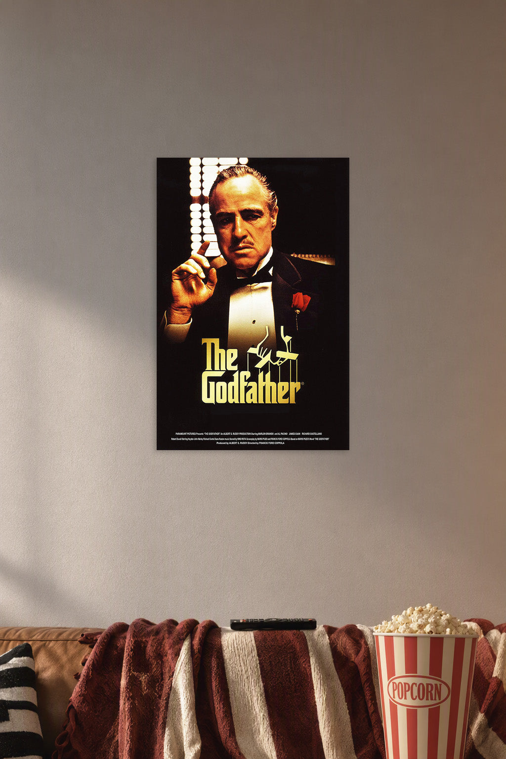 The Godfather in a cozy movie room above a brown sofa with popcorn.