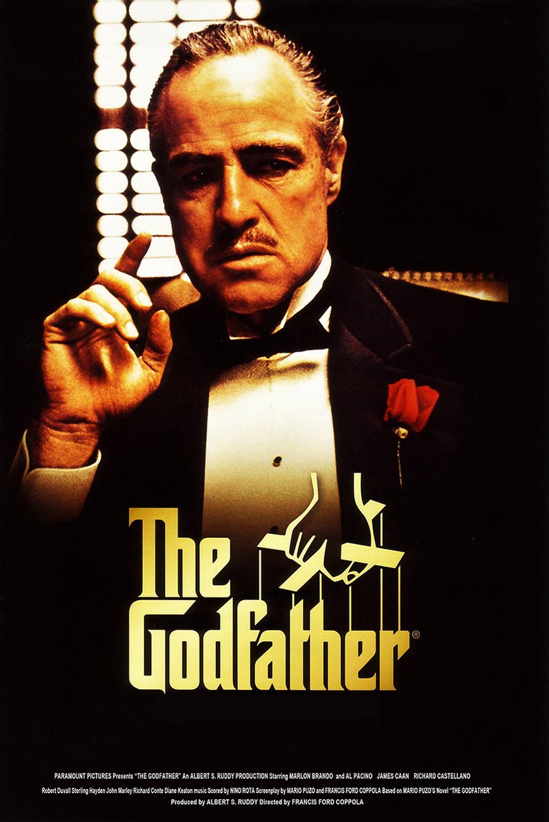 The Godfather poster features Vito Corleone in a black tuxedo with a red rose, posed before glowing window blinds.