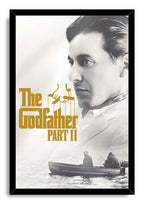 The Godfather Part II framed wall art print pairs a black frame with Michael Corleone’s portrait, gold logo, and two men in a boat.
