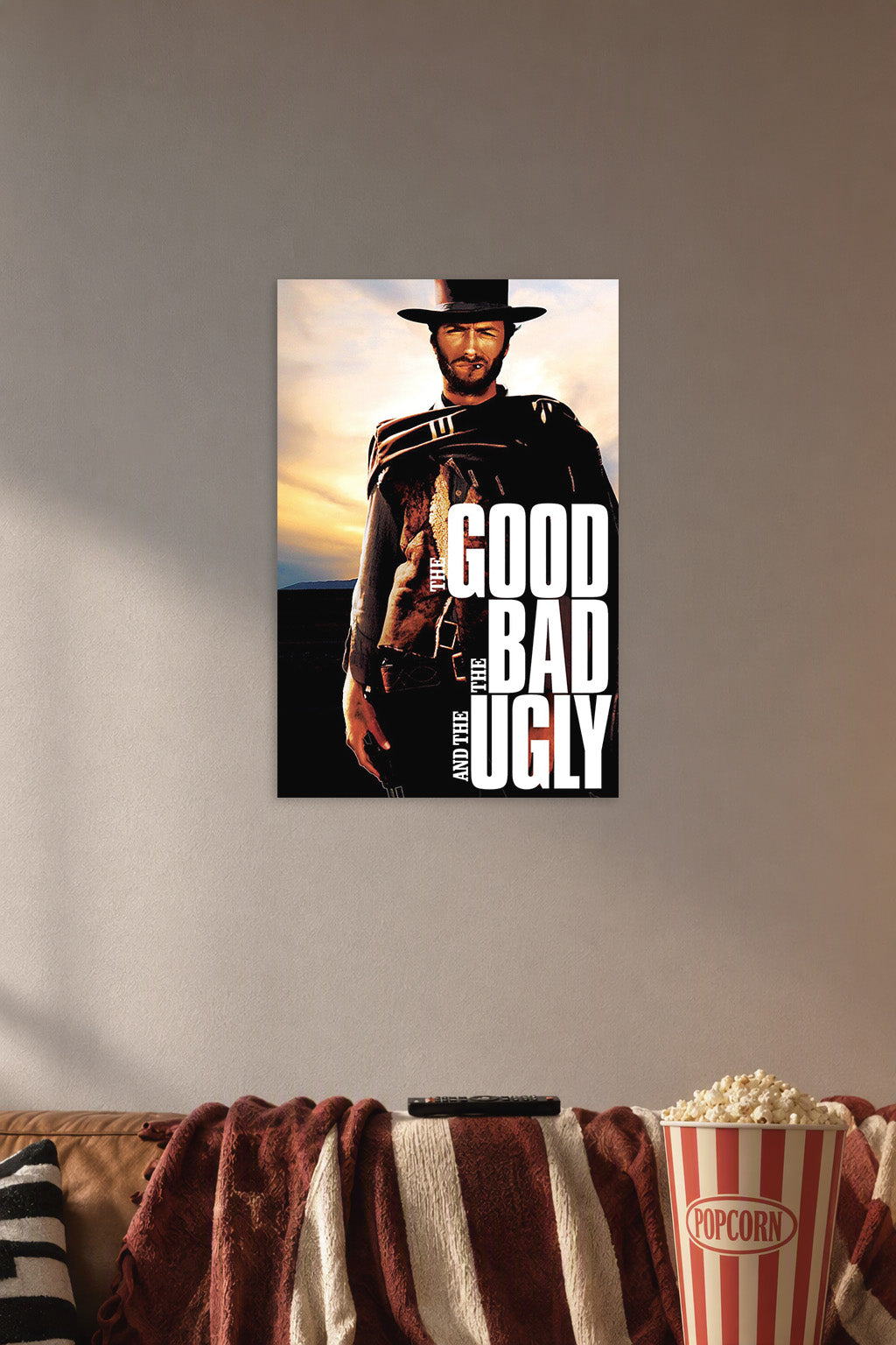 The Good The Bad and The Ugly Clint Eastwood in a cozy movie room above a brown sofa with popcorn.