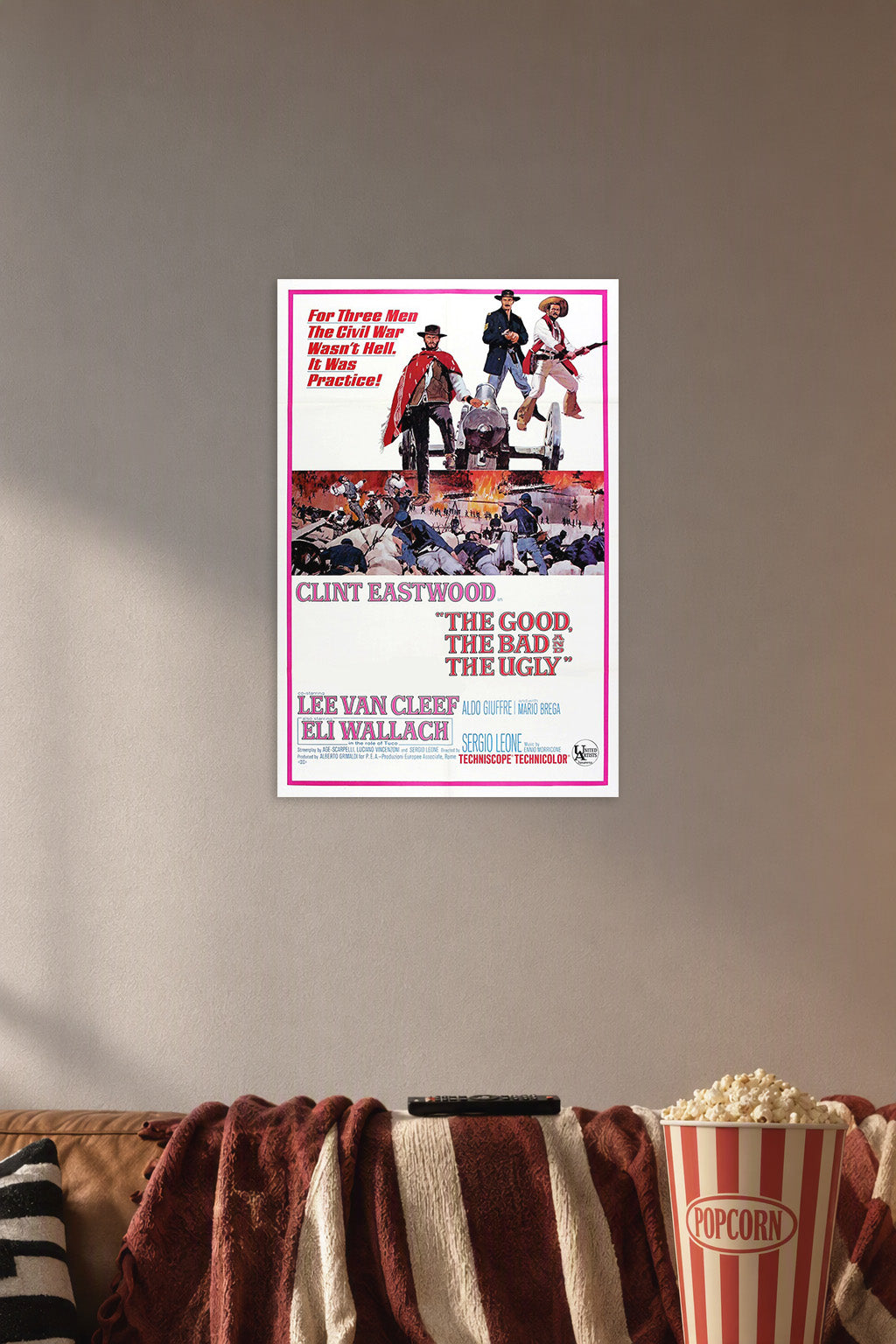 The Good, The Bad and The Ugly in a cozy movie room above a brown sofa with popcorn.