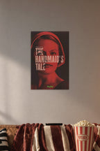 The Handmaid's Tale in a cozy movie room above a brown sofa with popcorn.