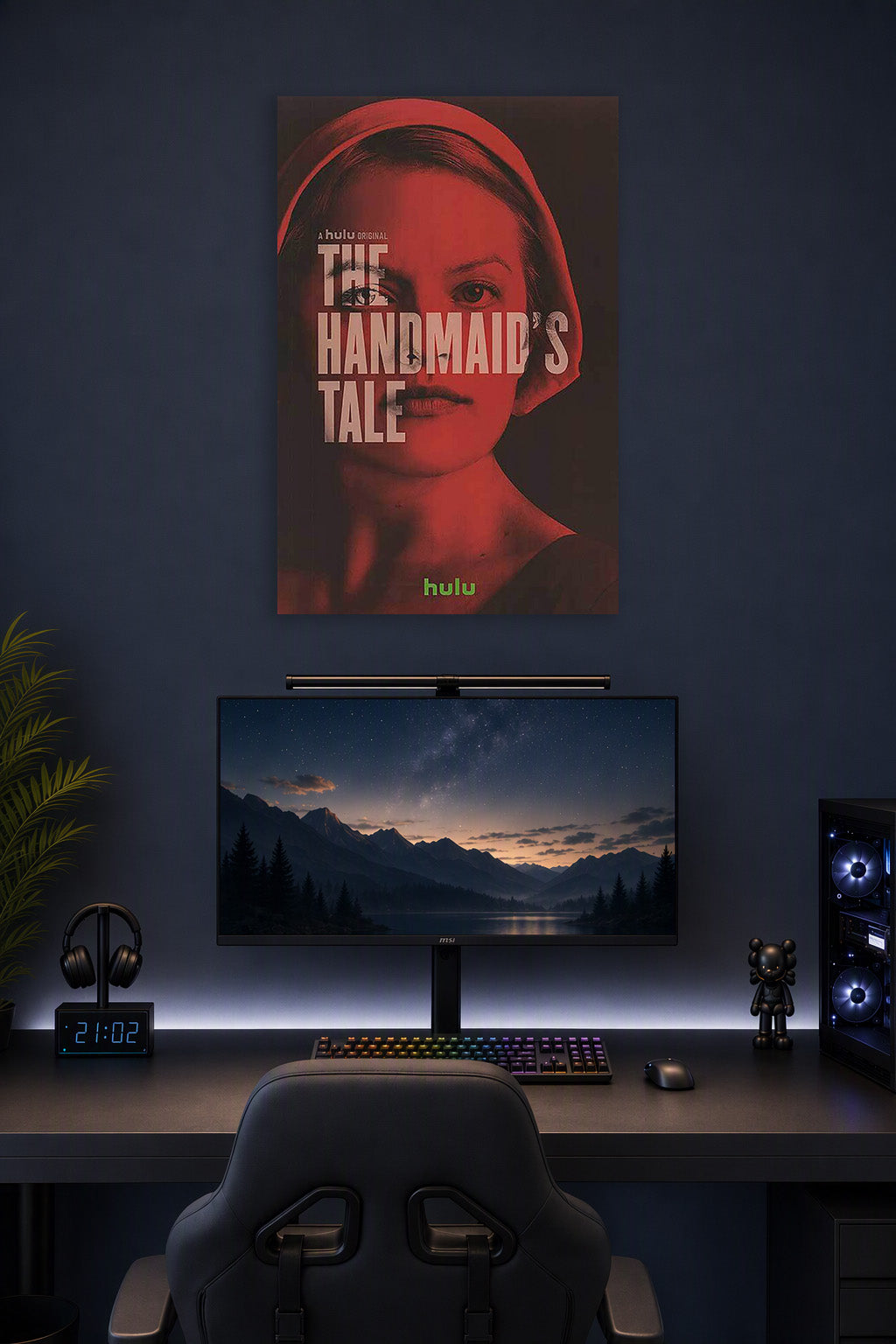 The Handmaid's Tale in a gaming desk setup above a monitor.