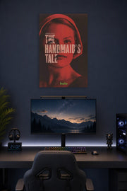 The Handmaid's Tale in a gaming desk setup above a monitor.