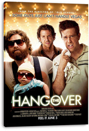 The Hangover canvas wall art print displays three men and a sunglass-wearing baby against a warm bulb-lit background.
