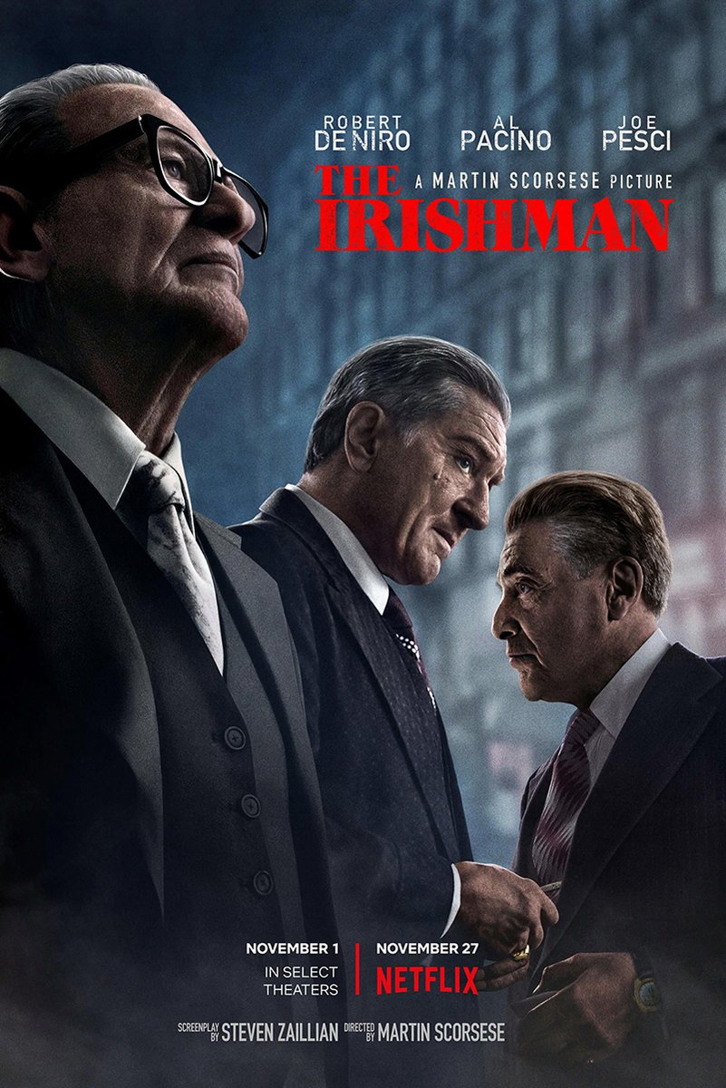The Irishman movie poster wall art print featuring three suited men against a smoky blue city backdrop with a bold red title.