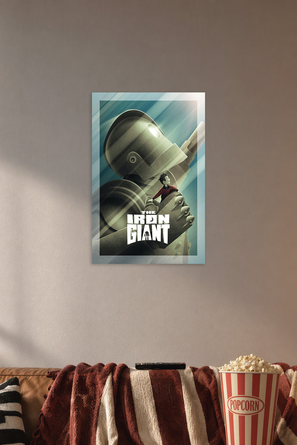 The Iron Giant Movie Poster in a cozy movie room above a brown sofa with popcorn.