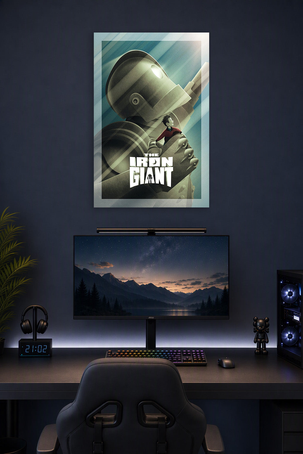 The Iron Giant Movie Poster in a gaming desk setup above a monitor.
