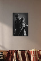 The Last of Us Joel and Ellie in a cozy movie room above a brown sofa with popcorn.