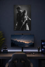 The Last of Us Joel and Ellie in a gaming desk setup above a monitor.