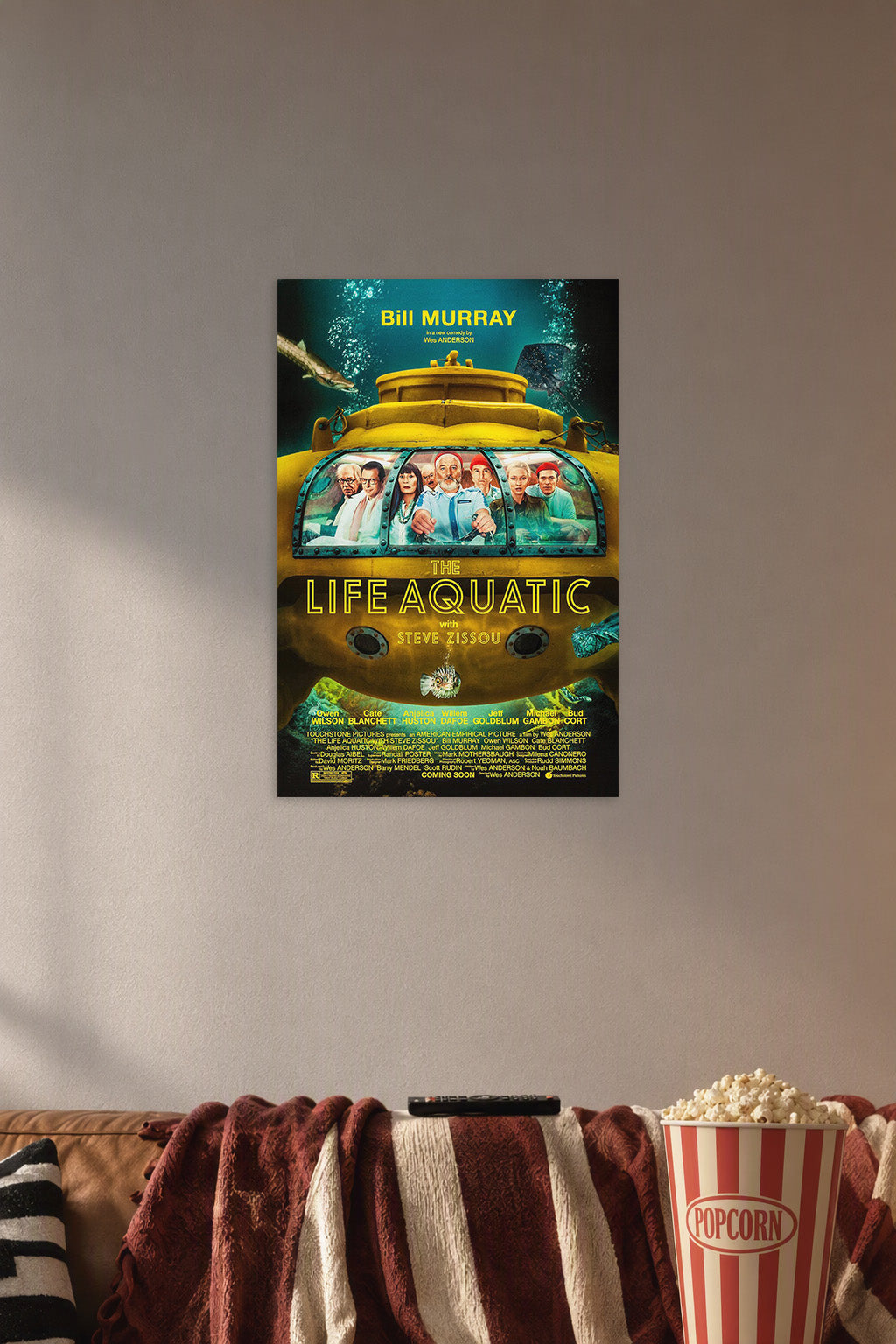 The Life Aquatic with Steve Zissou Movie Poster in a cozy movie room above a brown sofa with popcorn.