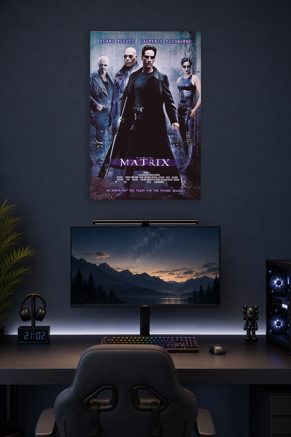 The Matrix Movie Poster in a gaming desk setup above a monitor.