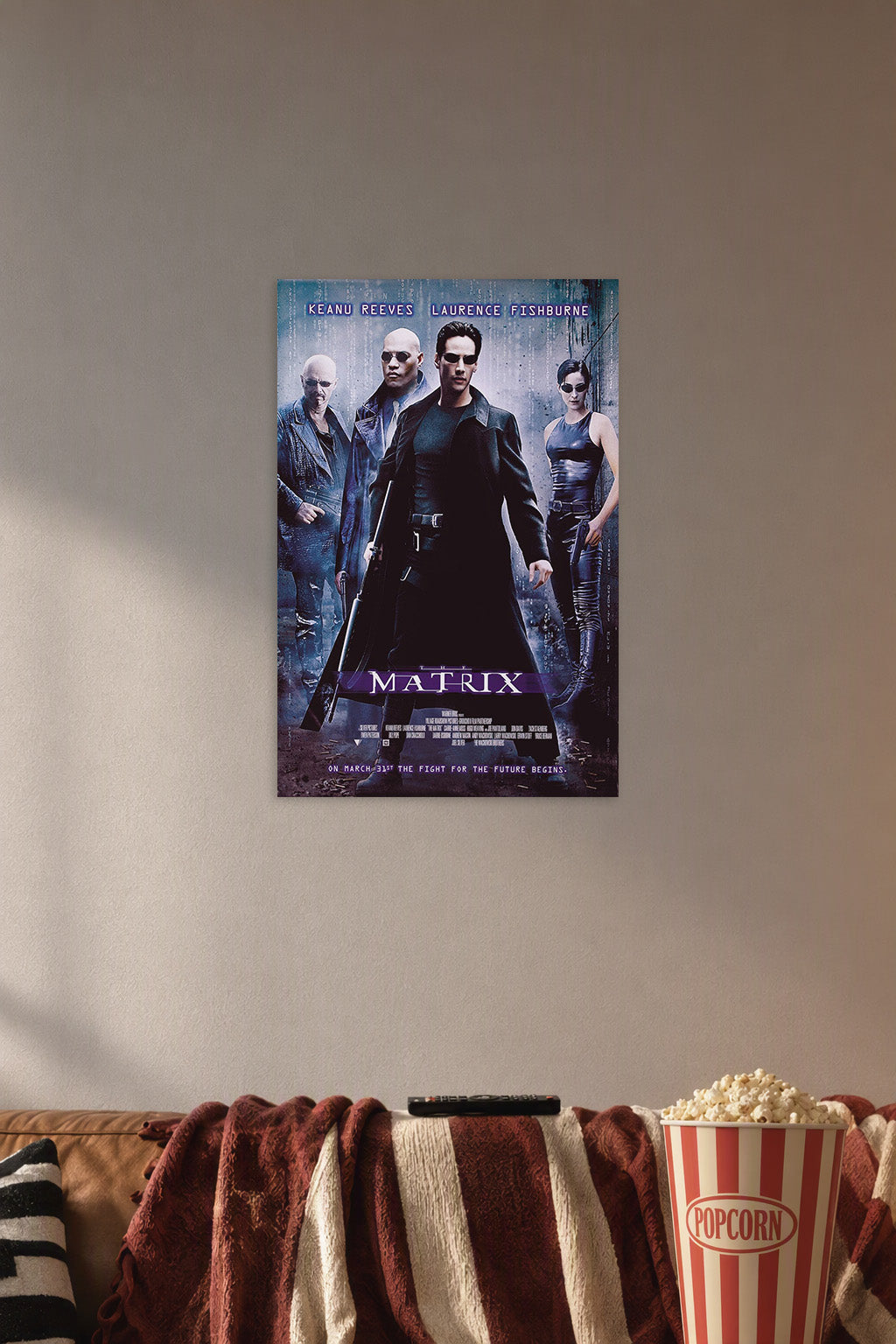 The Matrix Movie Poster in a cozy movie room above a brown sofa with popcorn.