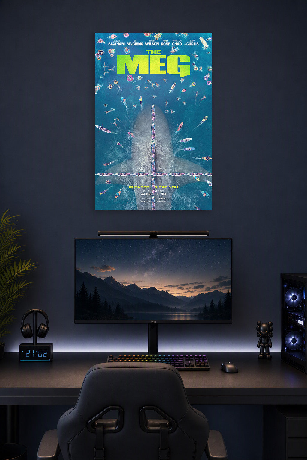 The Meg Movie Poster in a gaming desk setup above a monitor.