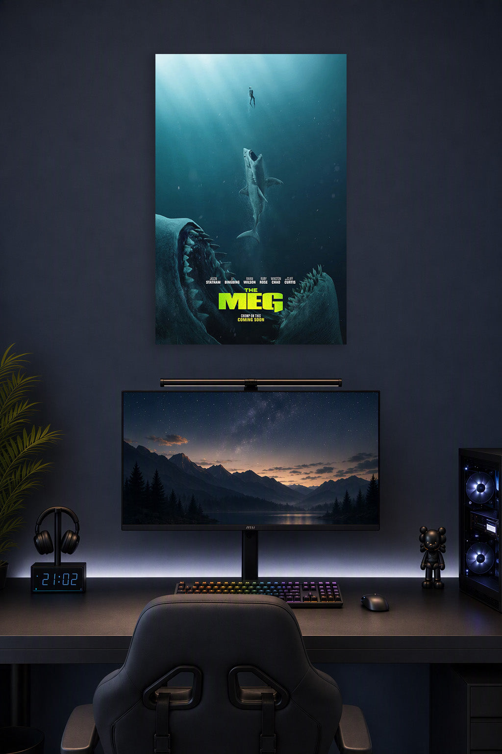 The Meg Movie Poster in a gaming desk setup above a monitor.
