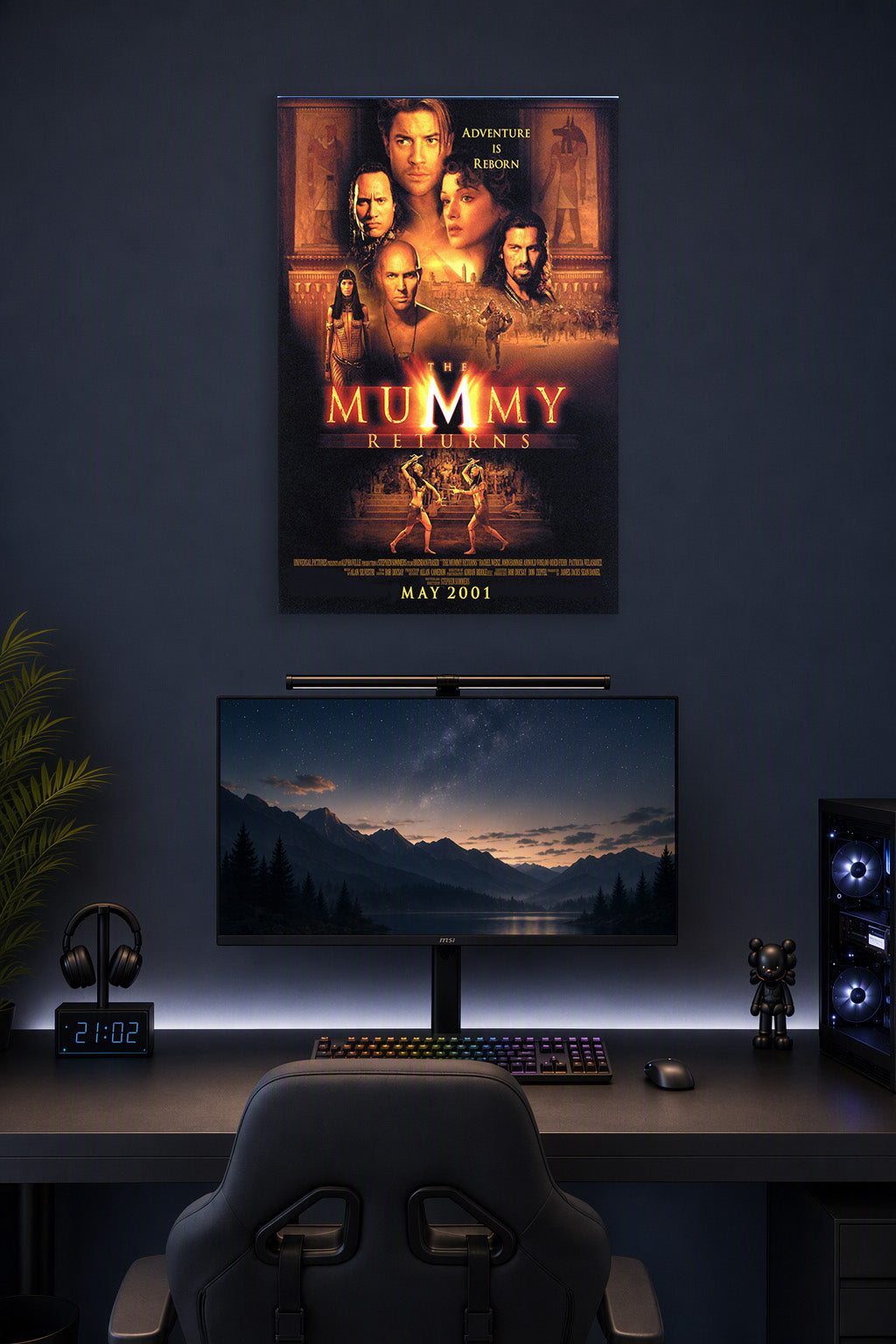 The Mummy Returns Movie Poster in a gaming desk setup above a monitor.