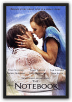 The Notebook framed wall art print features a couple embracing in the rain under a blue sky, enclosed in a slim black frame.