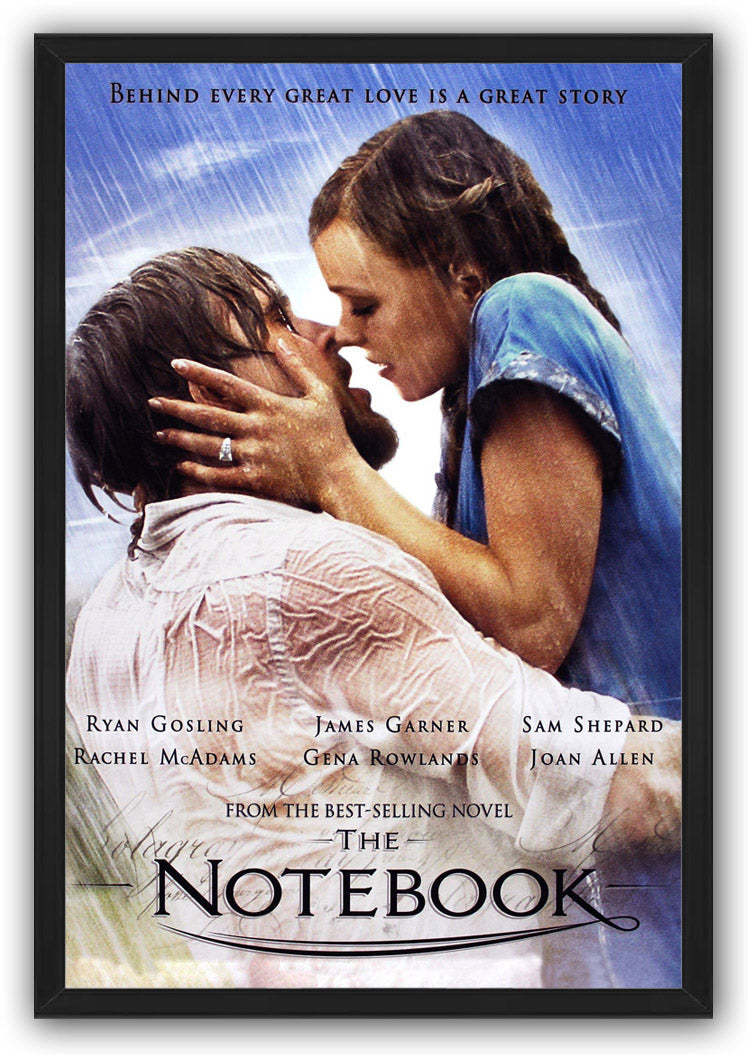 The Notebook framed wall art print features a couple embracing in the rain under a blue sky, enclosed in a slim black frame.