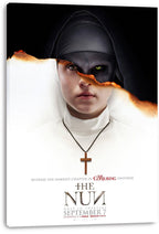The Nun canvas wall art print presents a nun in white split by a glowing burnt-paper tear that reveals a dark green-eyed face.