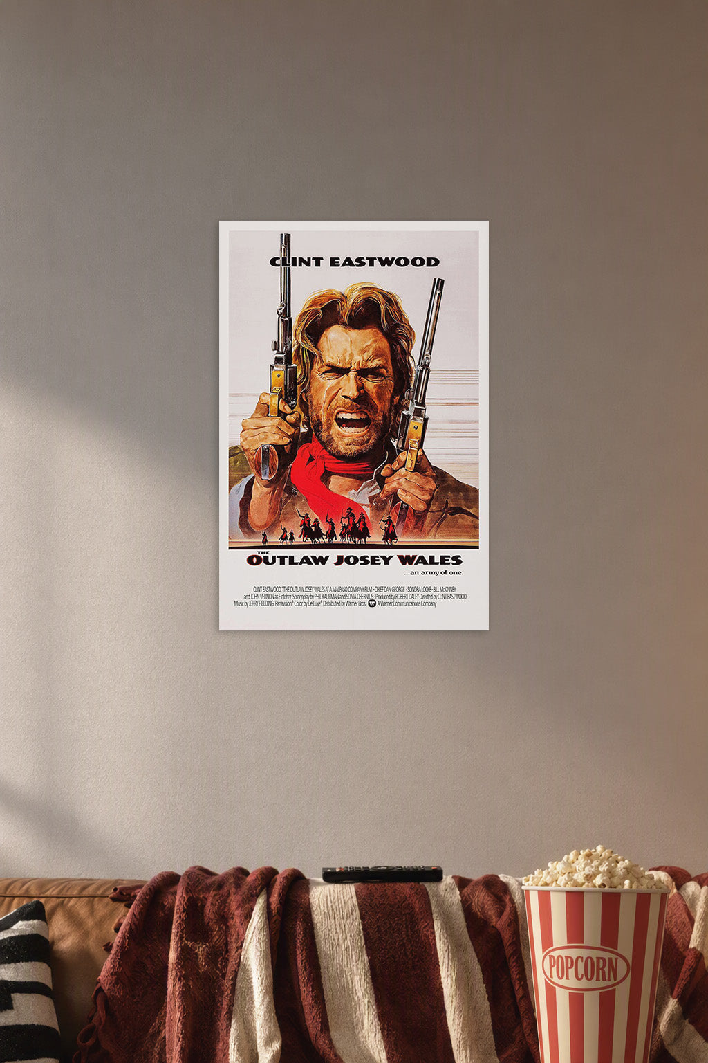 The Outlaw Josey Wales in a cozy movie room above a brown sofa with popcorn.