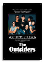 The Outsiders framed wall art print presents seven young men above bold white film typography in a slim black frame.