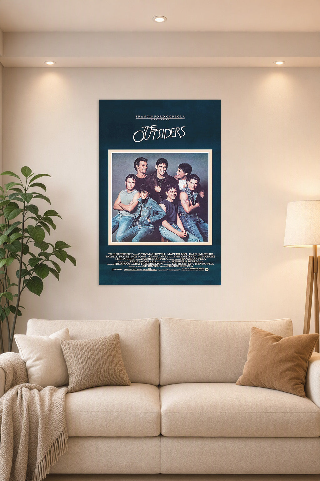 The Outsiders Movie Poster in a bright living room above a beige sofa.