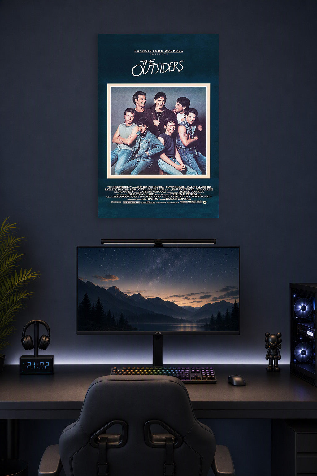 The Outsiders Movie Poster in a gaming desk setup above a monitor.