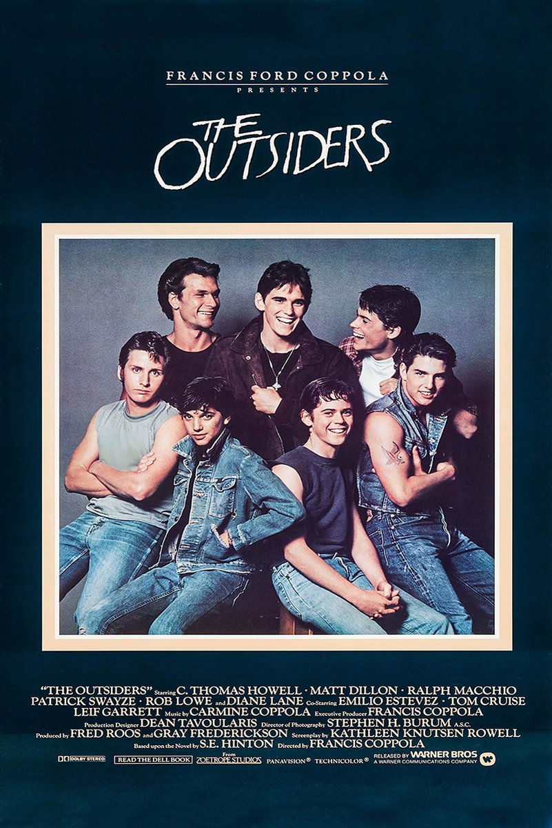 The Outsiders movie poster wall art features seven young men in denim beneath a white handwritten title on deep navy.