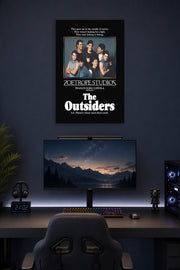 The Outsiders Movie Poster in a gaming desk setup above a monitor.