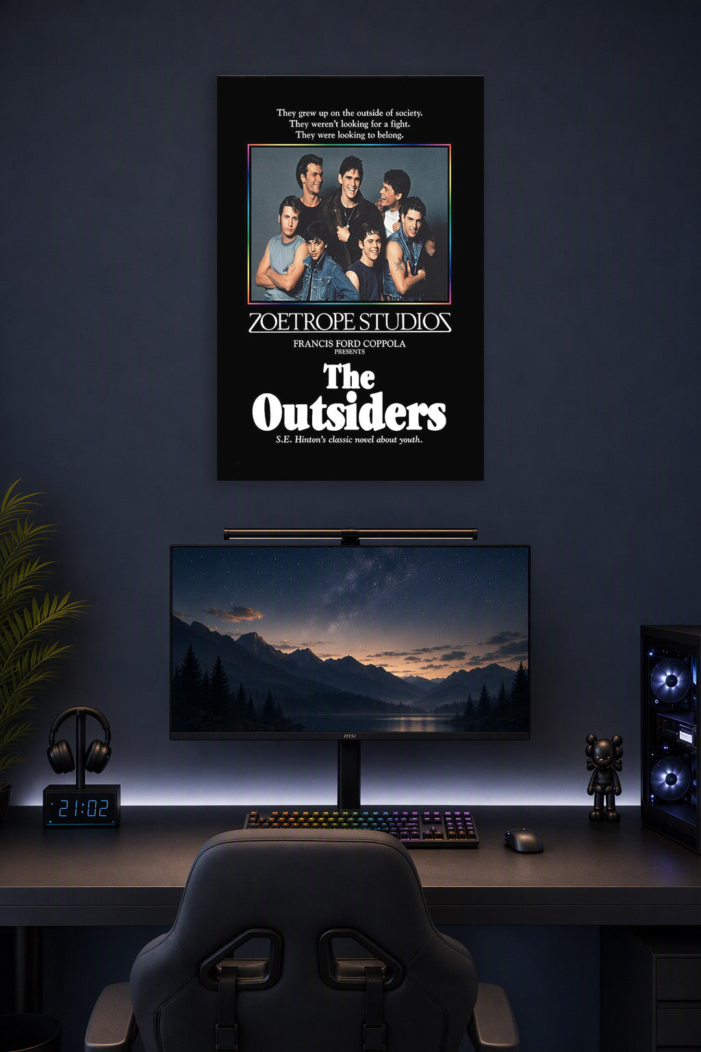 The Outsiders Movie Poster in a gaming desk setup above a monitor.