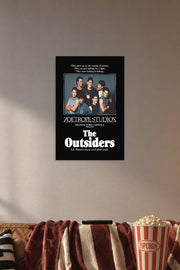 The Outsiders Movie Poster in a cozy movie room above a brown sofa with popcorn.
