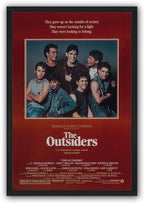 The Outsiders framed wall art print features seven young men in a central portrait with red surround, white text, and black frame.