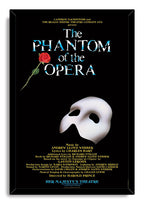The Phantom of the Opera framed wall art print with a black frame, red rose, white mask, blue typography, and gold credits.