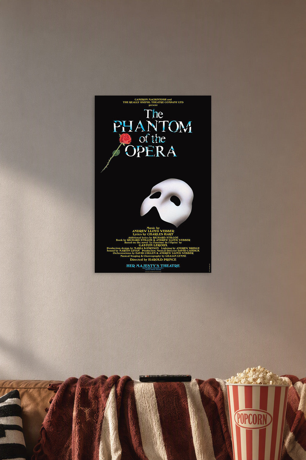The Phantom of the Opera in a cozy movie room above a brown sofa with popcorn.
