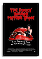 The Rocky Horror Picture Show framed wall art print features Dr. Frank-N-Furter reclining on red lips beneath bold dripping lettering.