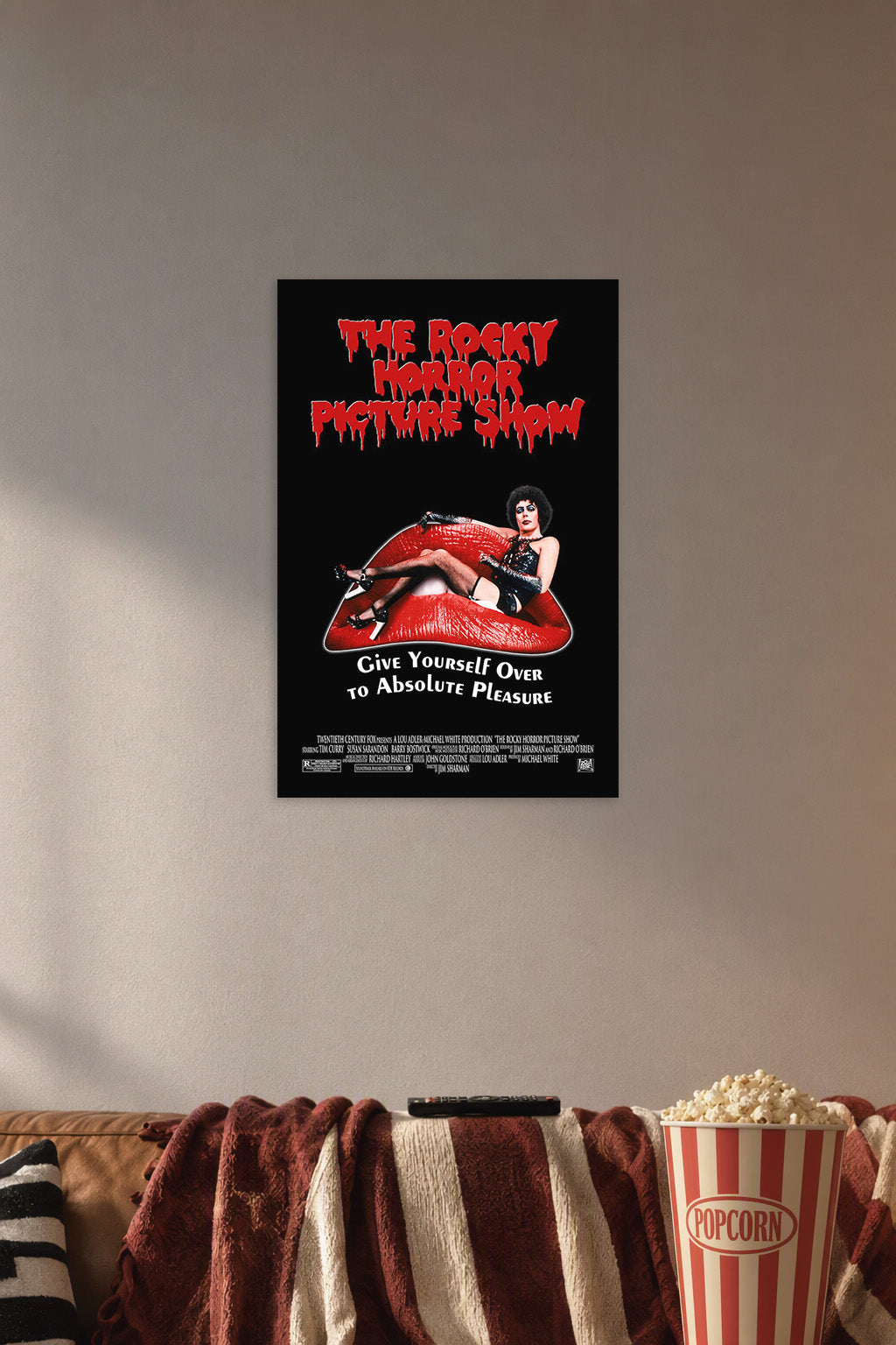 The Rocky Horror Picture Show Dr. Frank-N-Furter in a cozy movie room above a brown sofa with popcorn.