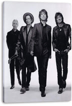 The Rolling Stones canvas wall art print displays four band members striding toward the camera in a monochrome studio portrait.