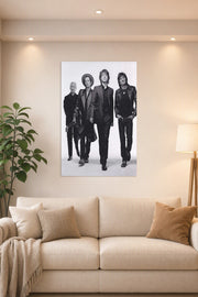The Rolling Stones in a bright living room above a beige sofa.