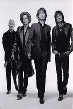 The Rolling Stones poster features four band members walking forward in black suits and leather jackets against a pale studio backdrop.