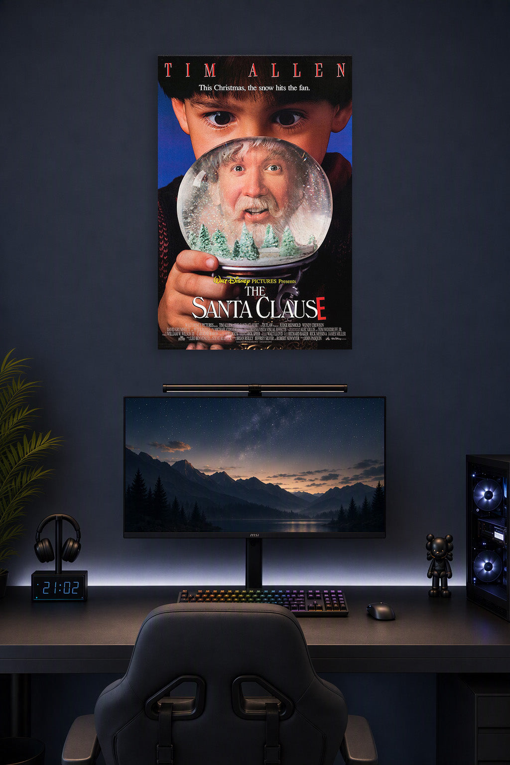 The Santa Clause Movie Poster in a gaming desk setup above a monitor.