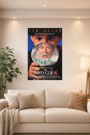 The Santa Clause Movie Poster in a bright living room above a beige sofa.